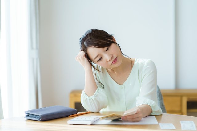 お金を持って悩む女性,車,修理,安い
